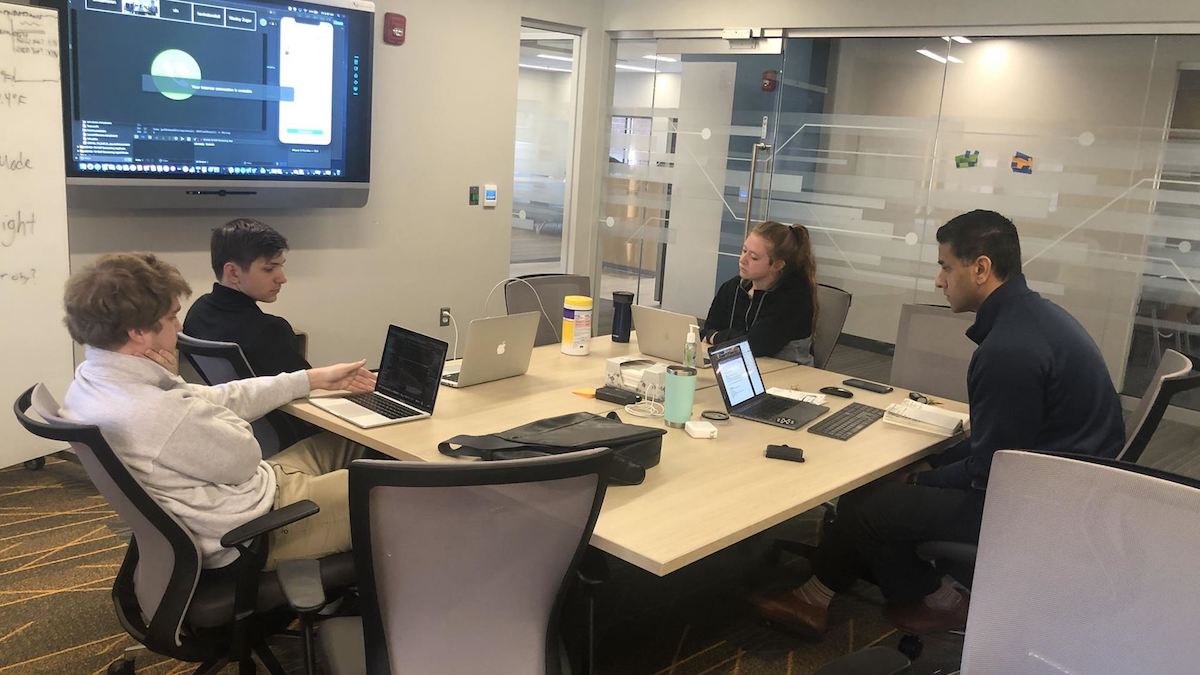 Students sitting at a conference table.