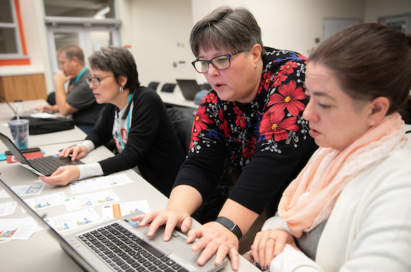 Two teachers working together at a computer