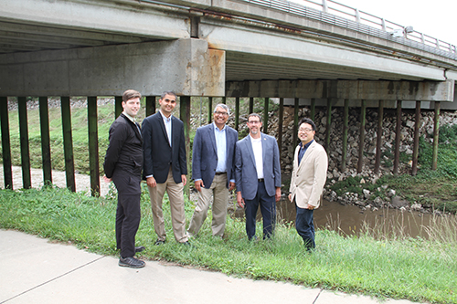 researchers standing on the banks of a river