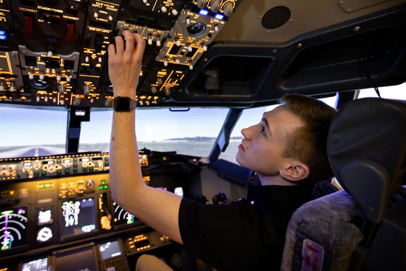 student in airplane simulator