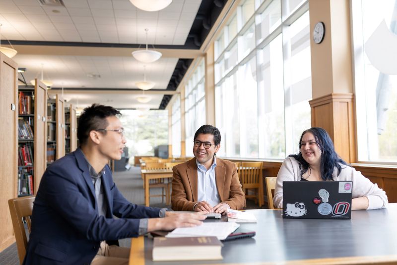 three people sitting at a table