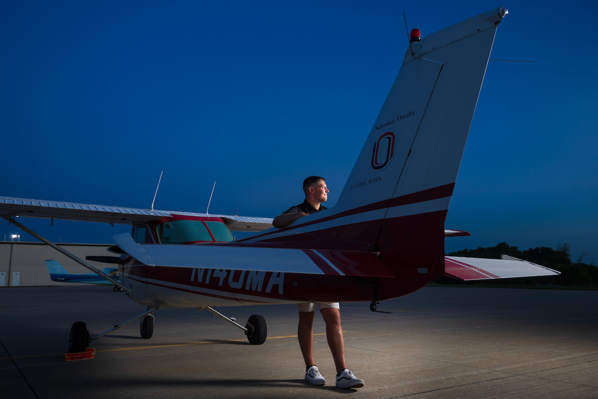 Student posed with an airplane.