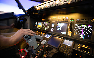 Pilot's hand on controls of an airplane