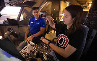 Student talking to instructor in the flight simulator