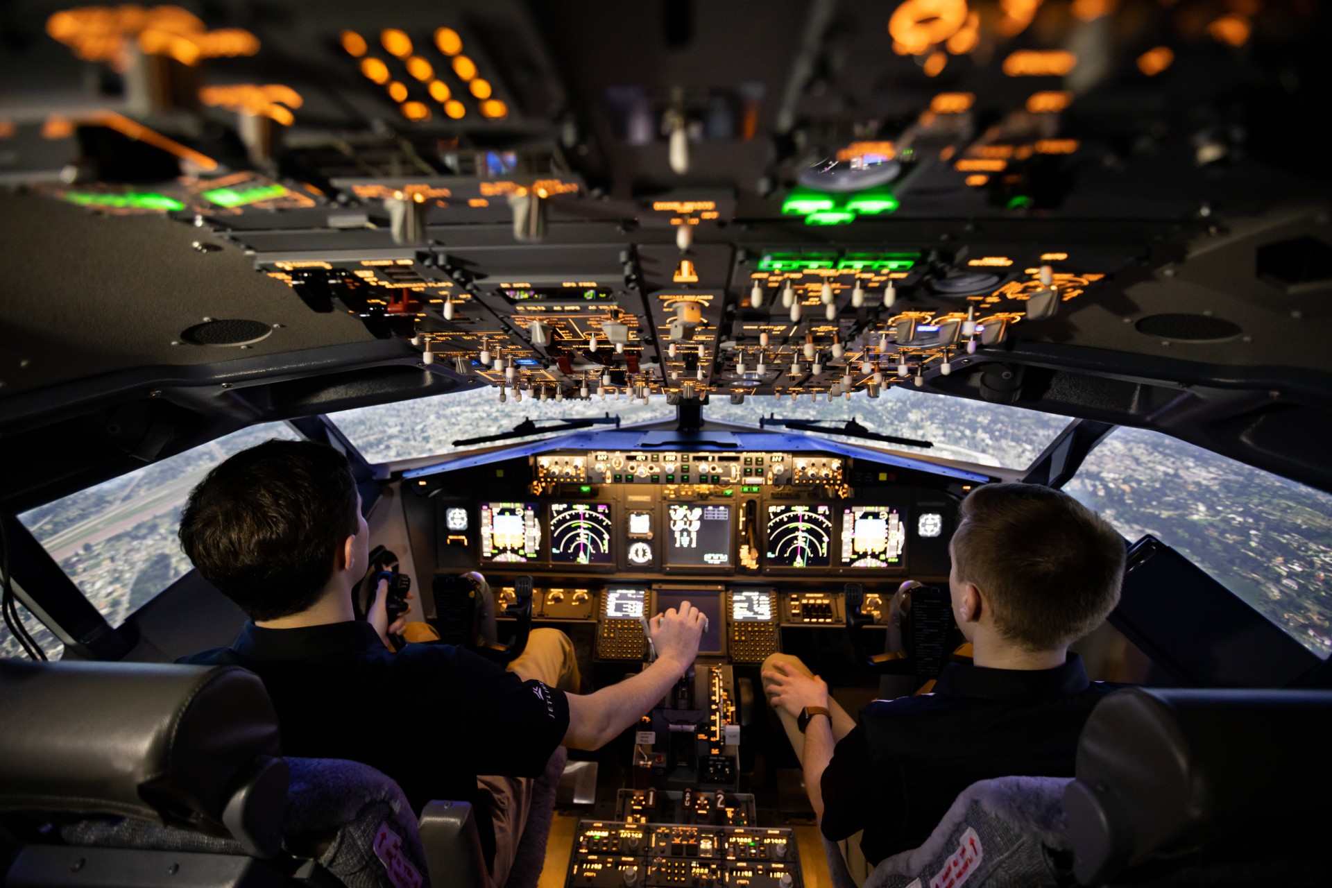 Four students walking on tarmac.