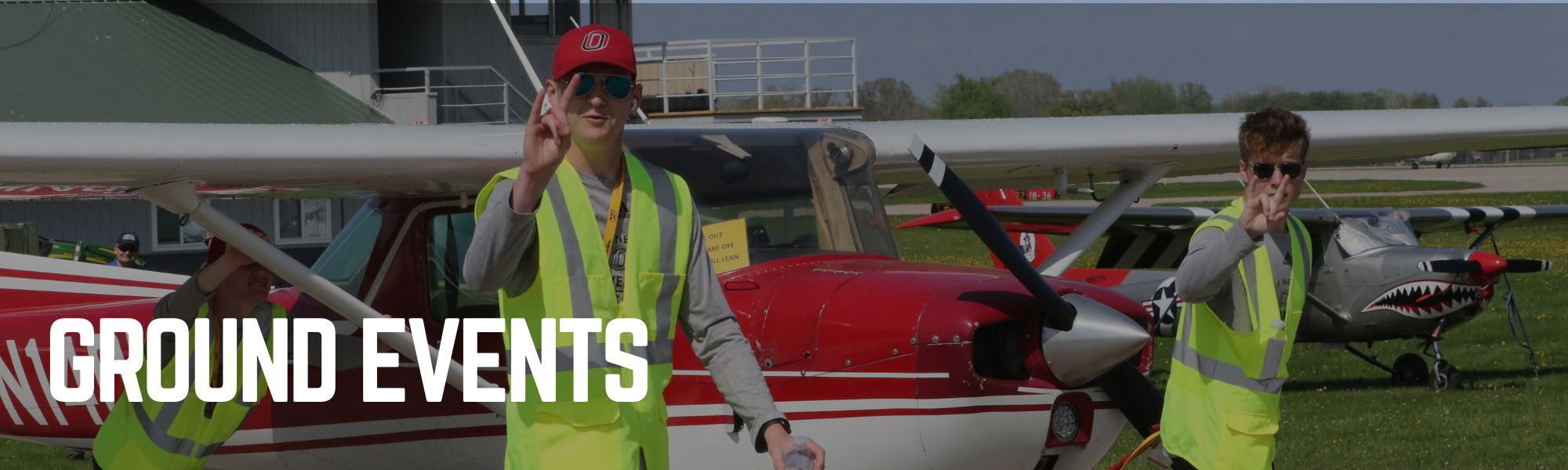Students pushing a plane. Captioned "Ground Events".