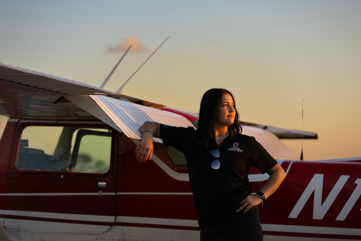 A student with a UNO airplane. 