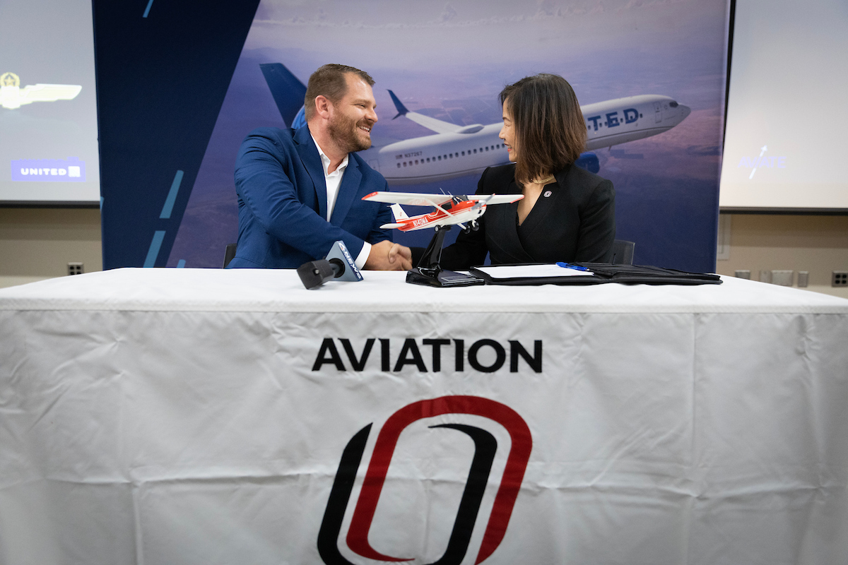 UNO dean and Aviate representative shake hands