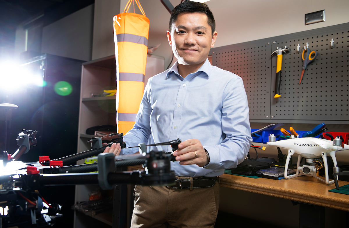 Teacher holding a drone.