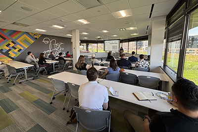 Director Josie Gatti Schafer presenting to community members about the Greater Omaha Chamber's Young Professionals survey results