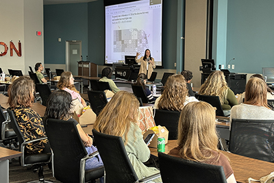 Director Josie Gatti Schafer presenting at the UNO Goldstein Human Rights Forum about transportation structures and Challenges
