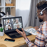 person on laptop in an online meeting working from home 