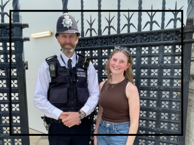 Student posing next to a British police officer.