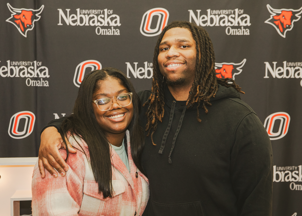 Student and significant other posing for a photo at a graduation reception.
