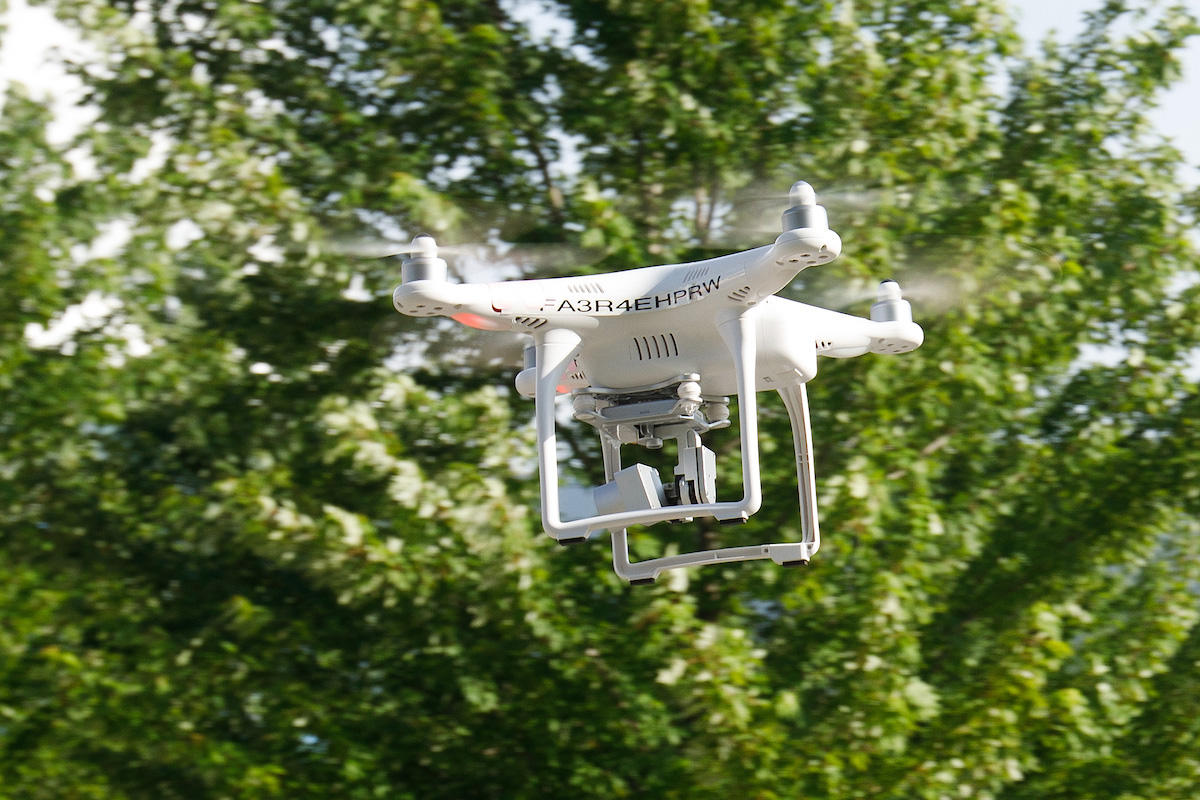 a drone flying among trees