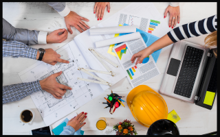 multiple hands over paper plans and tools for emergency evacuations.