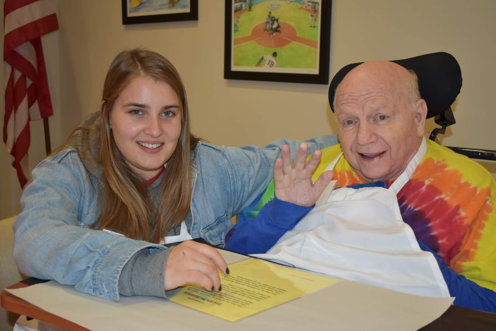 Gerontology student with older adult wearing a colorful shirt