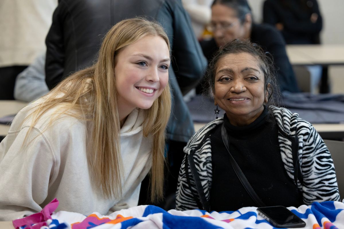 student and adult smiling