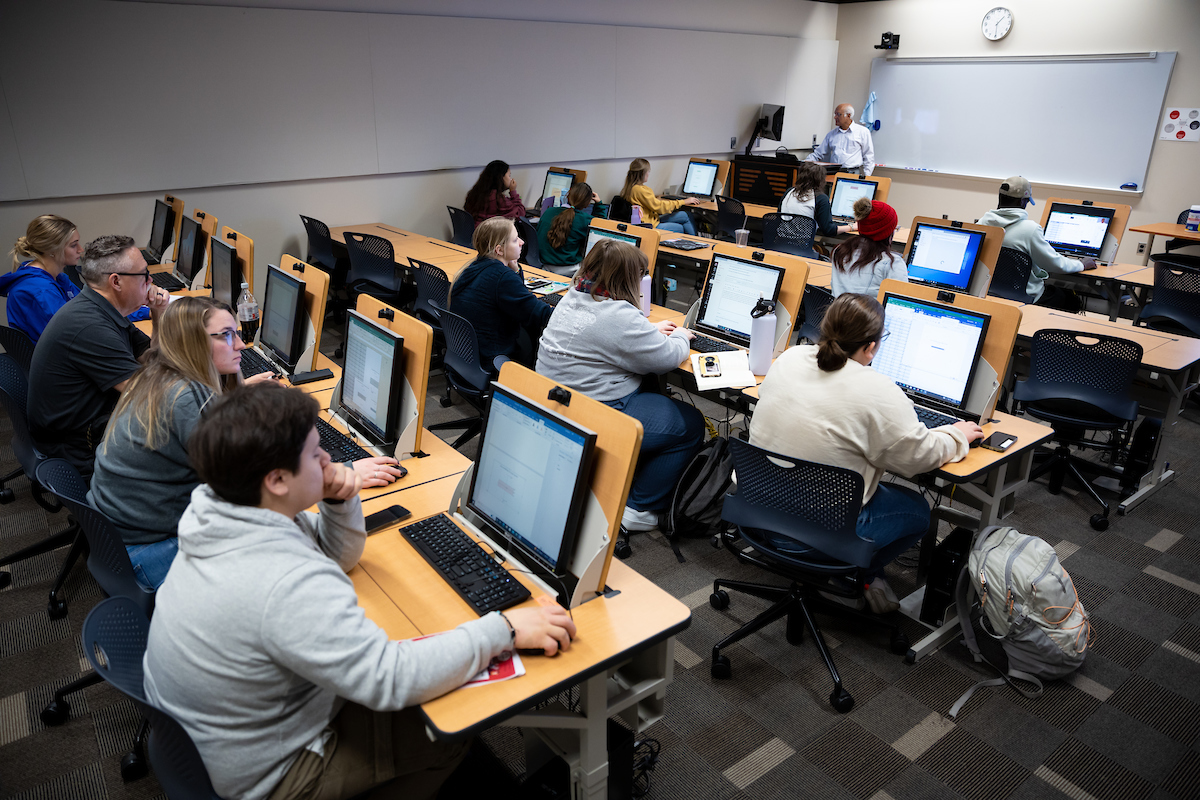 classroom full of students on laptops