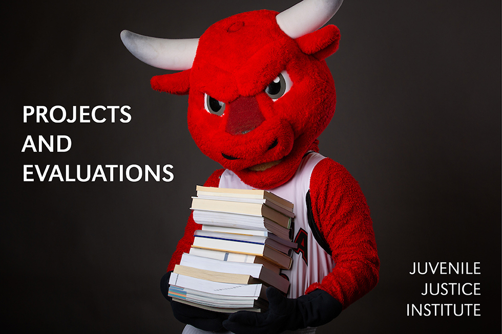 photo of UNO mascot Durango holding books