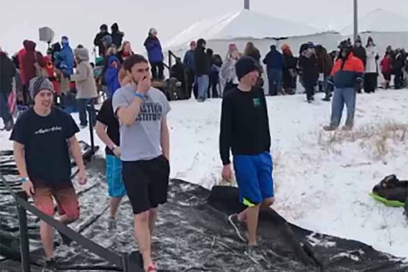 Aviation students heading into the freezing waters of Lake Cunningham. 