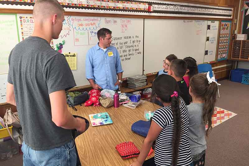 Emergency management students teaching third graders about preparedness.