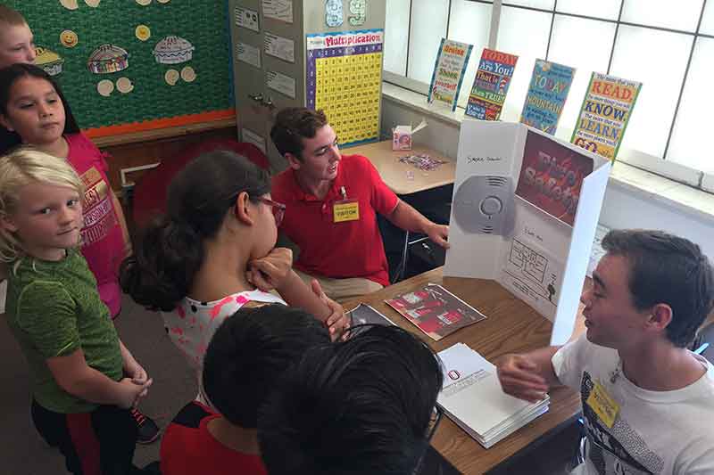 Emergency management students teaching third graders about preparedness.