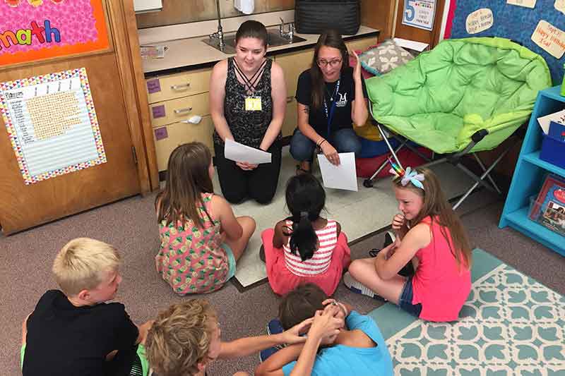 Emergency management students teaching third graders about preparedness.