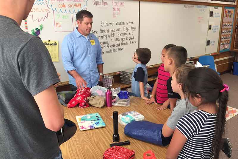 Emergency management students teaching third graders about preparedness.