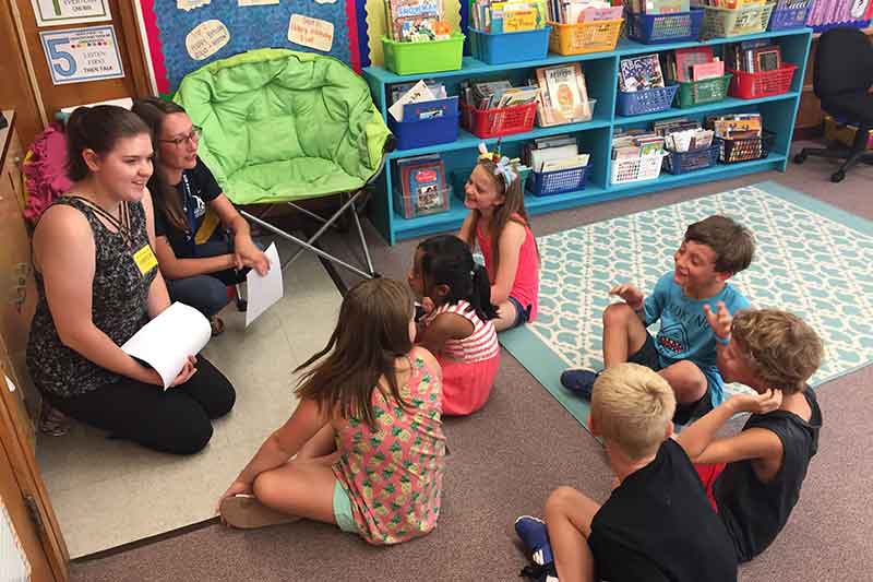 Emergency management students teaching third graders about preparedness.