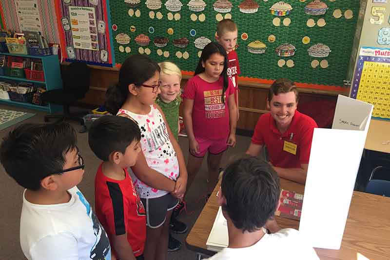 Emergency management students teaching third graders about preparedness.