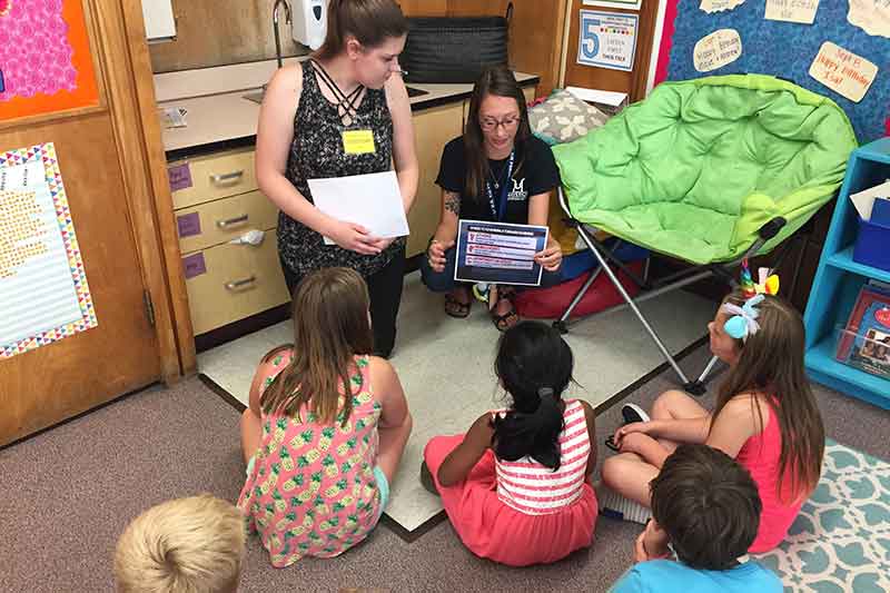 Emergency management students teaching third graders about preparedness.