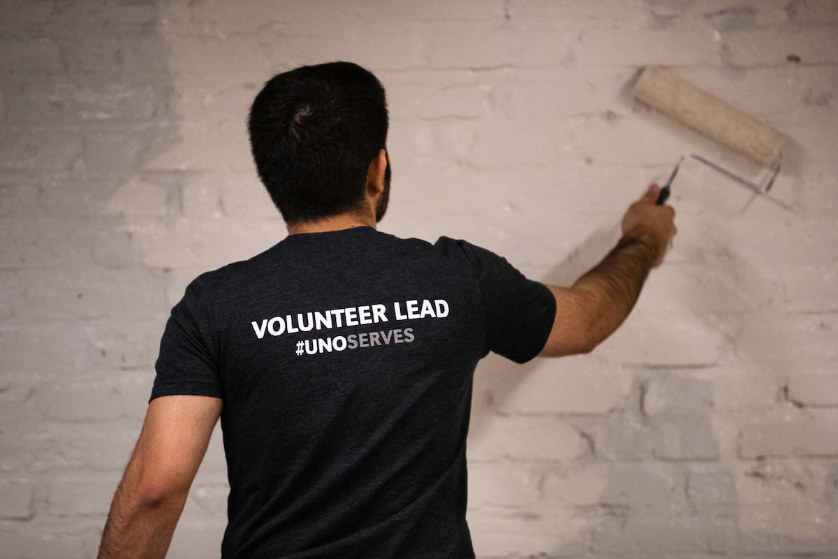 A student adds a new coat of paint to a wall as part of one of UNO's days of service.