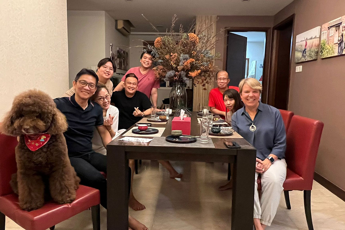 Anne Hobbs with a group of ex-offenders at a dinner at a pastor's house.  