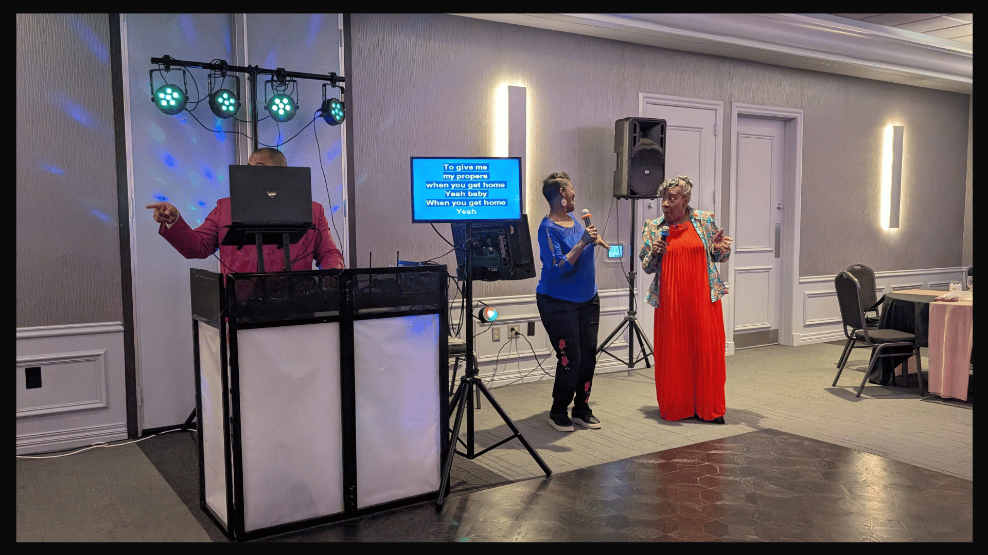 Two women singing karaoke.