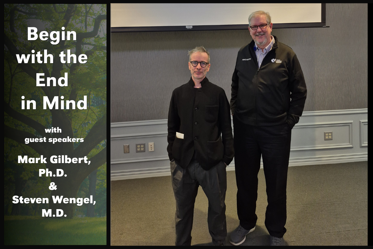Dr. Mark Gilbert and Dr. Steven Wengel standing in front of a screen with a tree in the background.