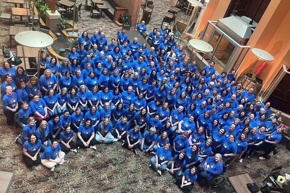 Group of clerks wearing blue 50 years t-shirts.