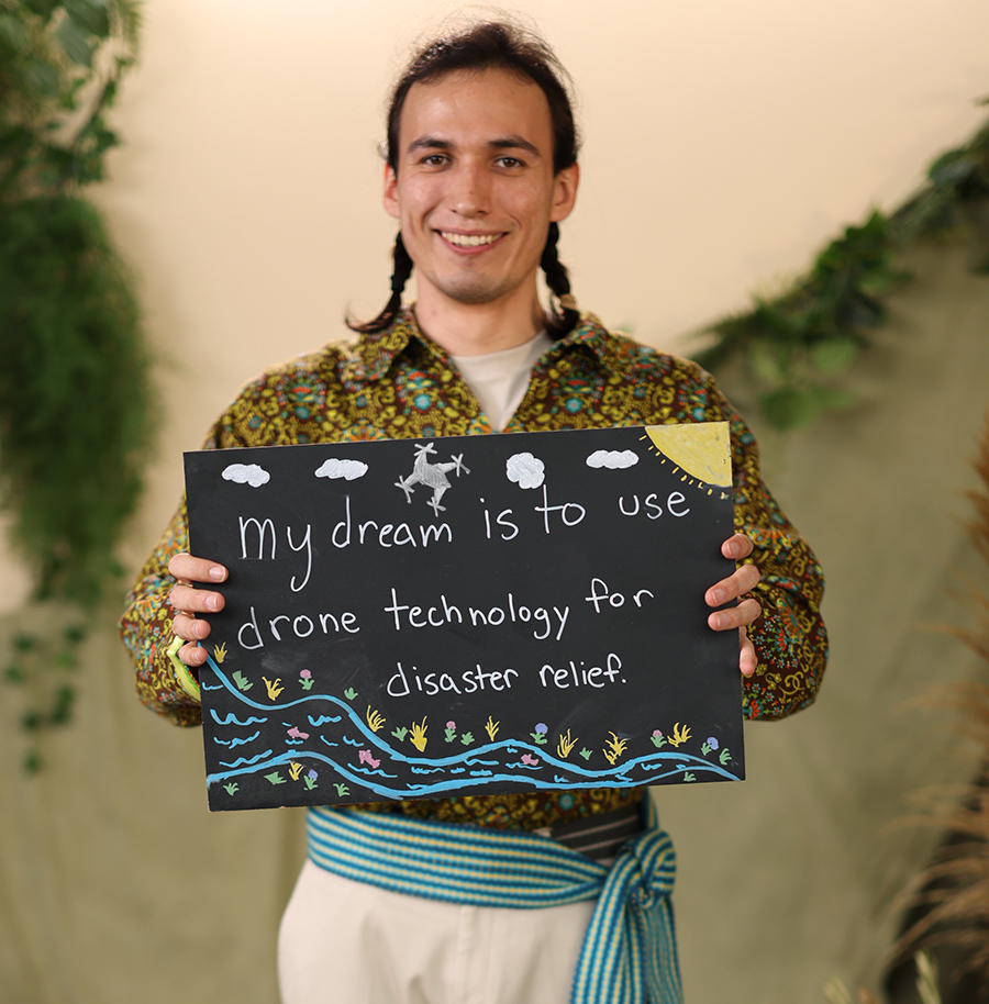 student holding drone sign