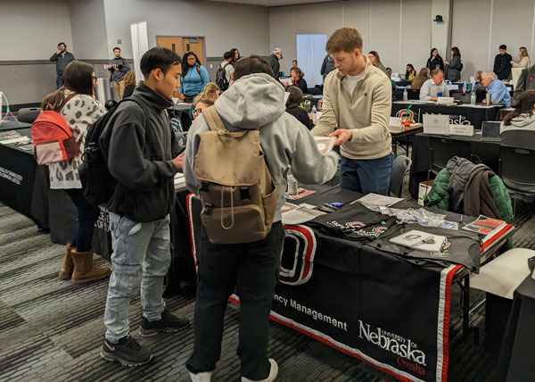 logan at booth handing out informaiton