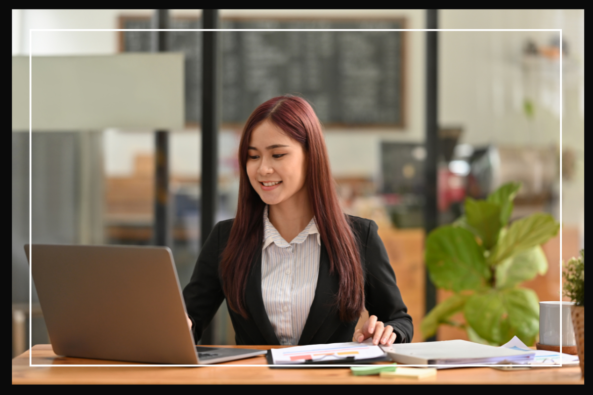 student working on a laptop sitting at a desk.