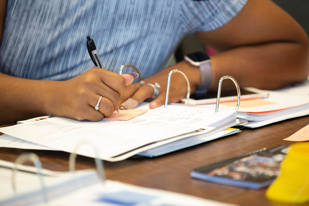 student writing in a notebook.