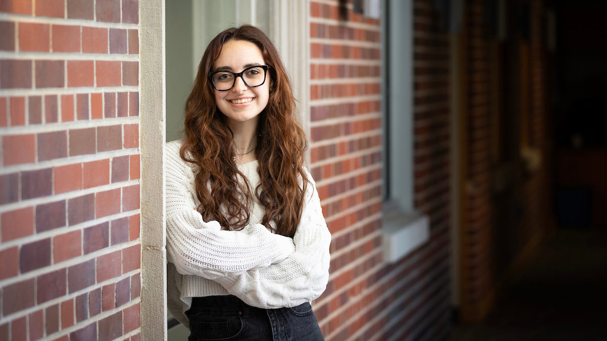 Aislyn Tyler poses near a brick wall