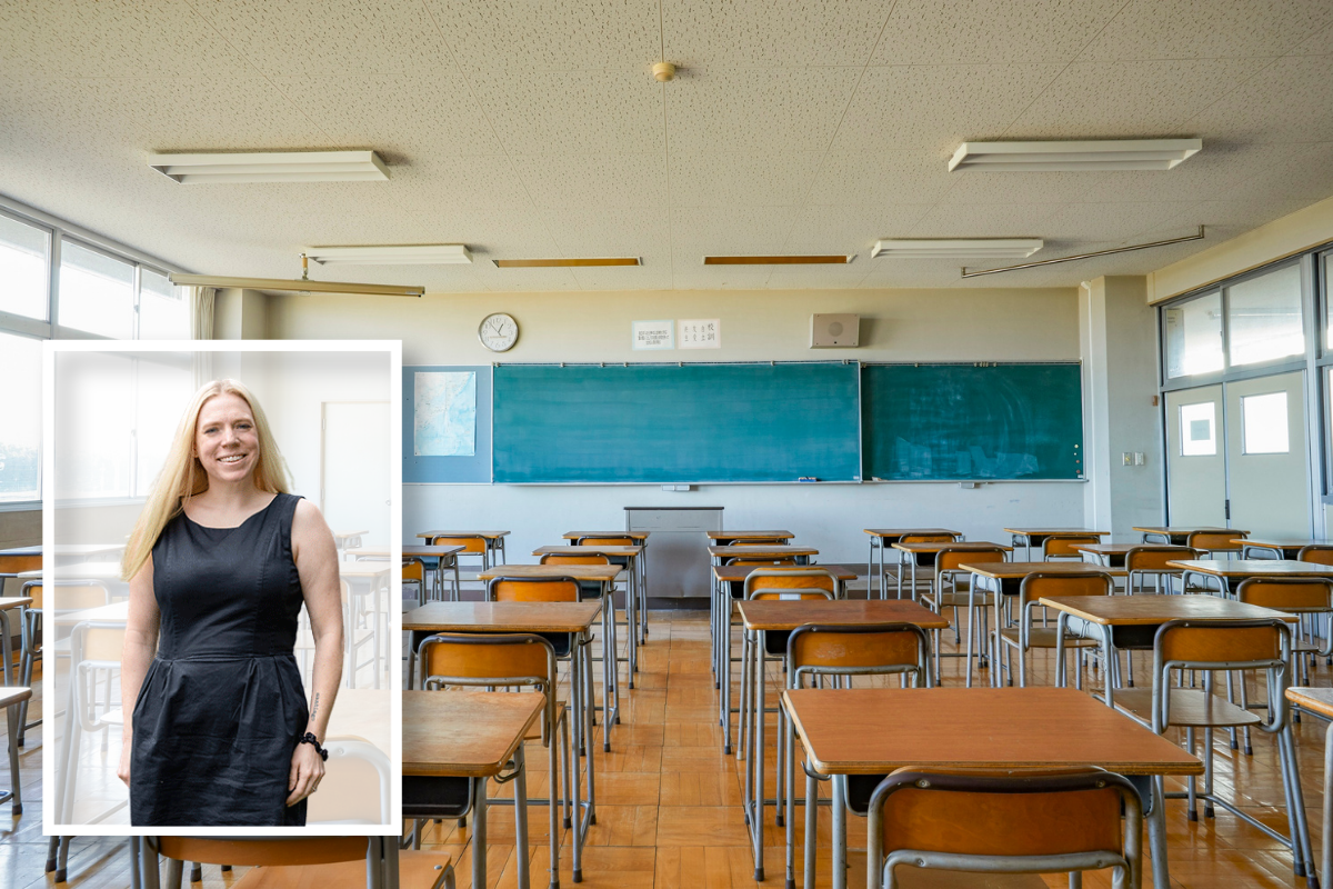 Empty classroom with desks and a chalkboard.