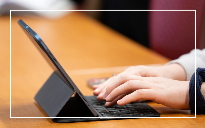 Hands typing on a laptop.