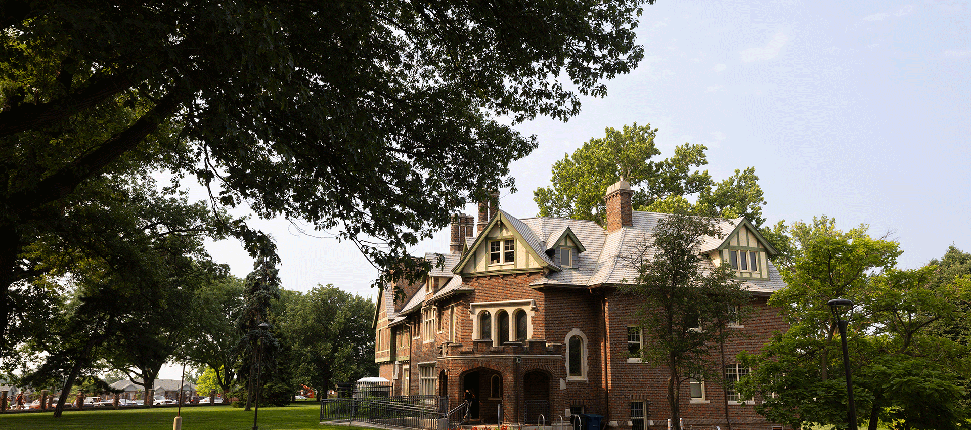 Exterior view of Hayden House, a historic brick building surrounded by trees on the University of Nebraska at Omaha campus, where the Collegiate Recovery Community is located.
