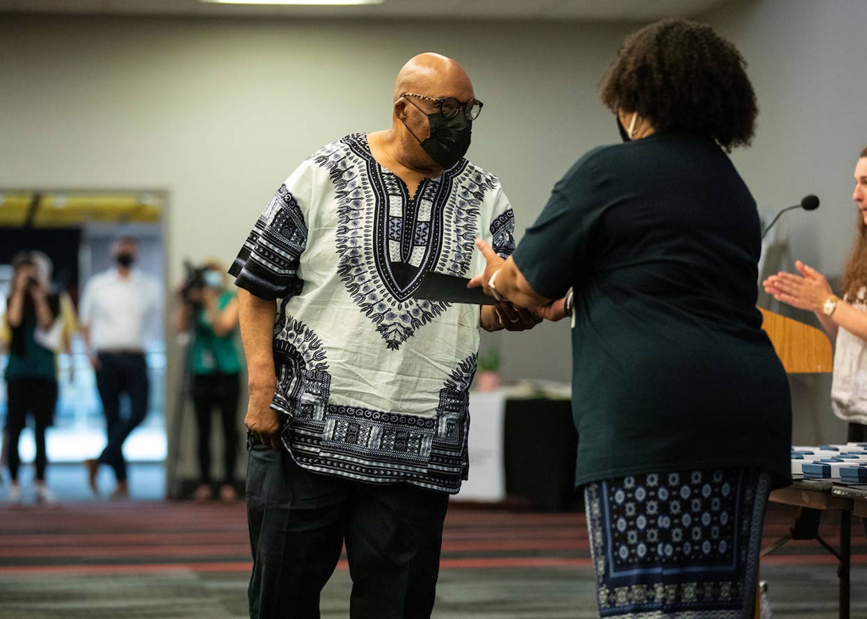 a member of the omaha 54 preparing to receive an award 