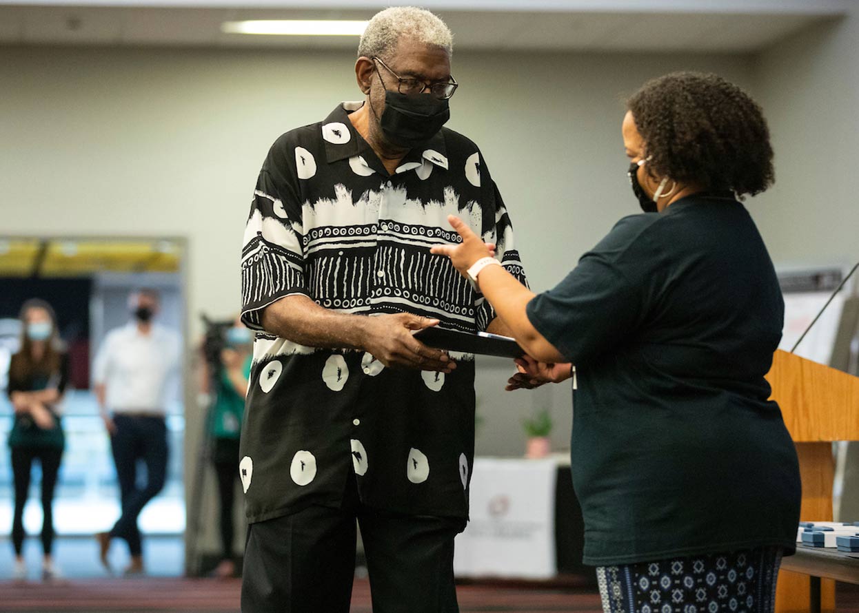 a member of the omaha 54 preparing to receive an award 