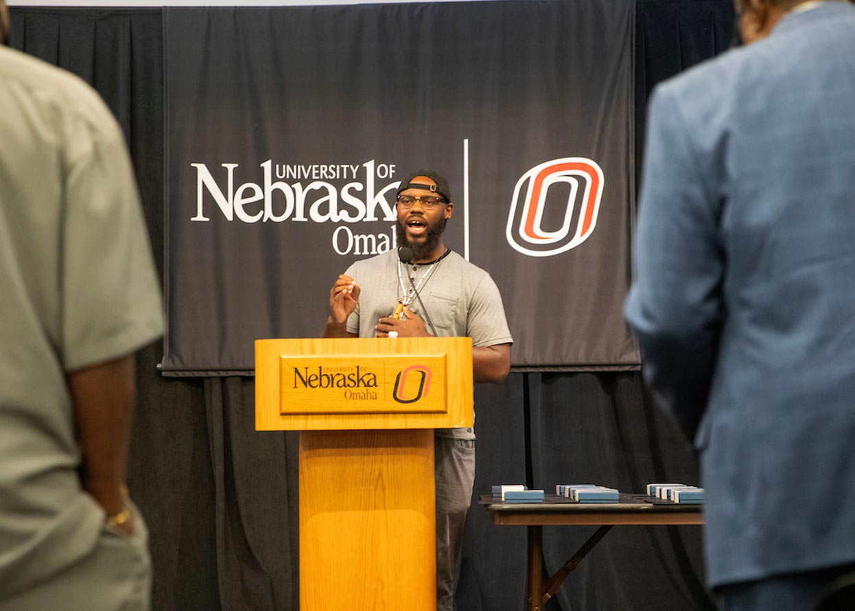 speaker with a microphone at a podium 