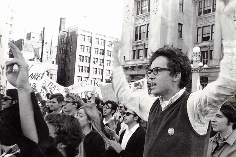 People standing and chanting in a protest against the Vietnam War