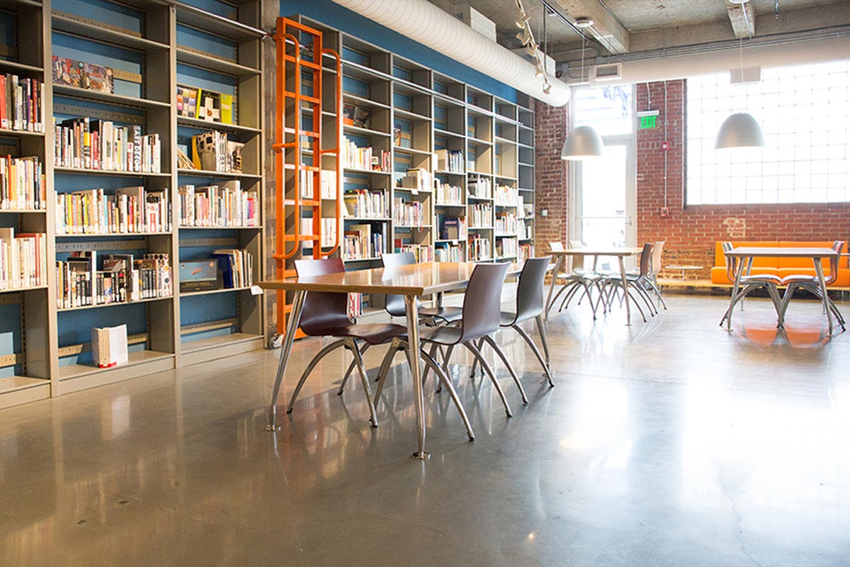 tables and chairs in a room with natural light shining in 